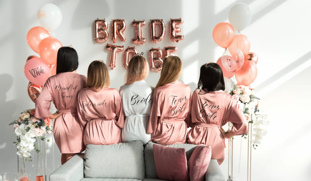 Bride with girlfriends in silk robes at a bachelorette party