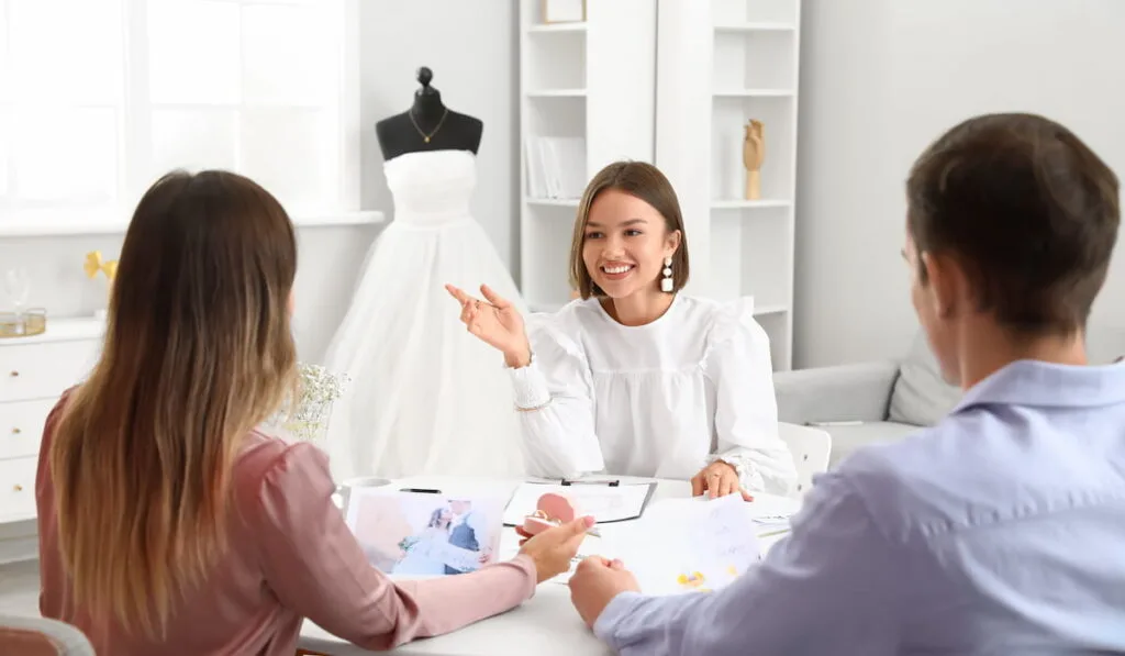 Female wedding planner referring and discussing about ceremony 
