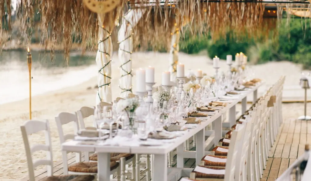 dinner table set up for beach wedding party