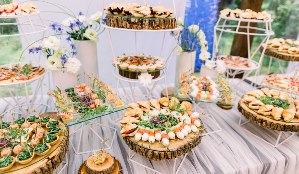Catering buffet and rustic decor, outdoor wedding party with healthy food snacks
