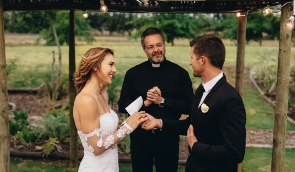 Happy young bride and groom exchanging wedding vows 