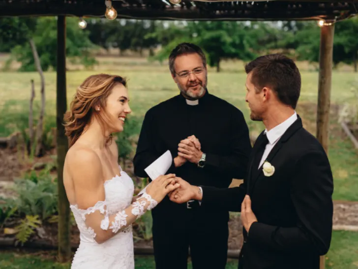 happy young bride and groom exchanging wedding vows