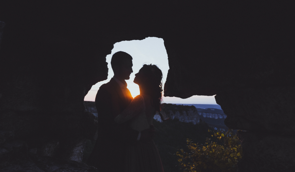 Wedding photo shoot at mountain Mangup in Crimea. Silhouette of loving couple newlyweds