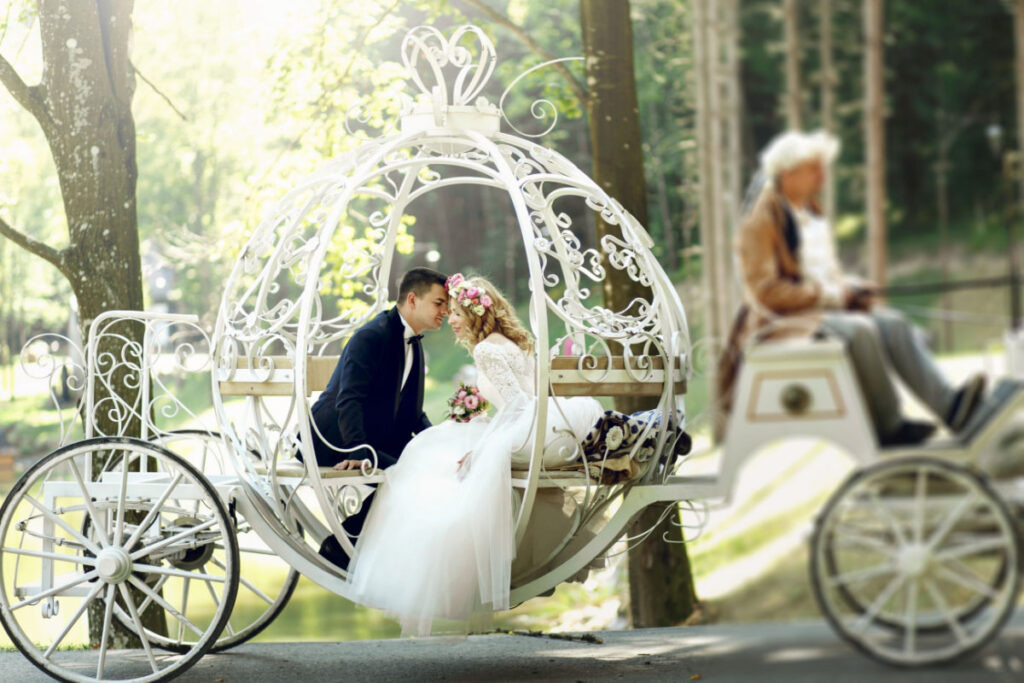 bride and groom riding on a fairytale like carriage