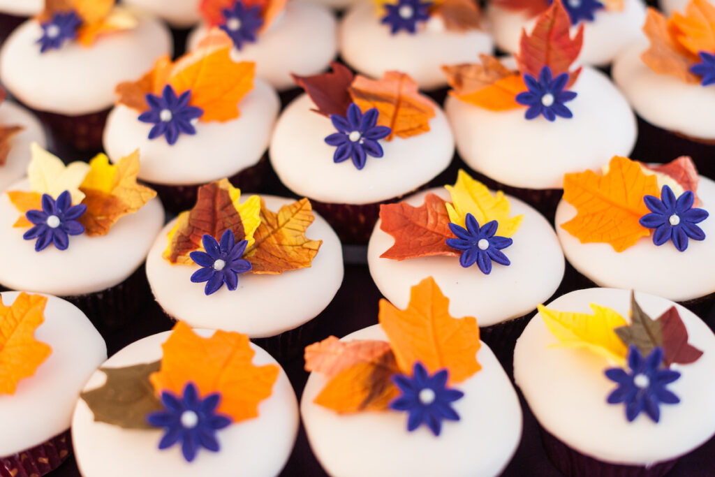 wedding cupcakes with autumn leaves and blue star toppers